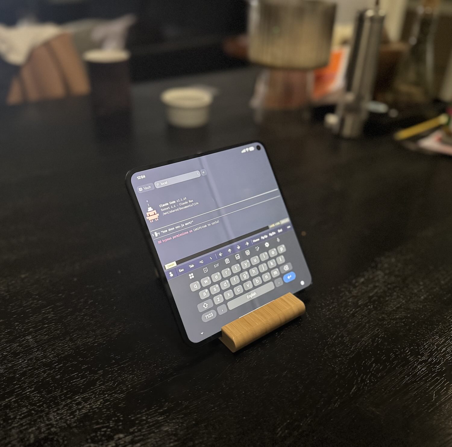 Pixel Fold 9 unfolded on a stand, showing Terminus with Claude Code running